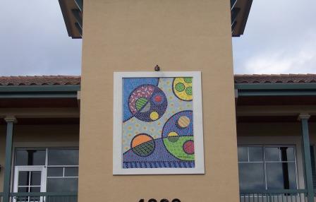 Artist's conceptual painting of bacteria in frame on side of building